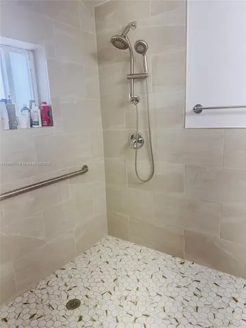 a kitchen with stainless steel appliances granite countertop a stove a sink and white cabinets