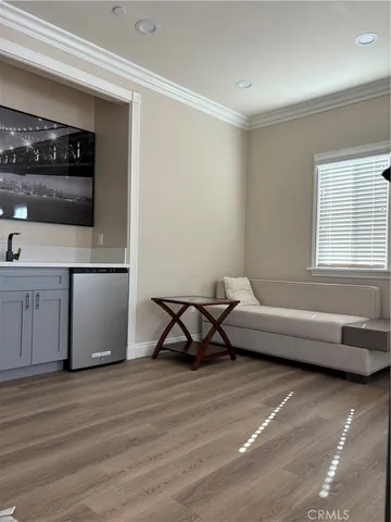 a living room with a couch and a stove next to a window