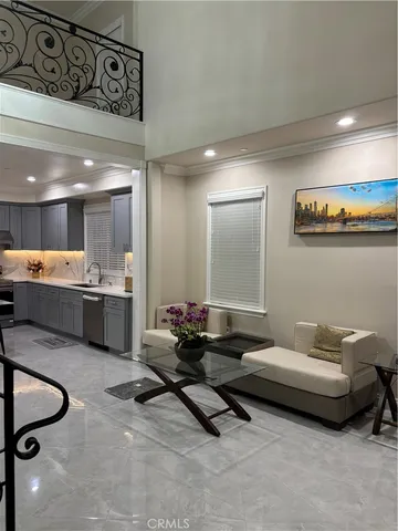 a living room with furniture and kitchen view