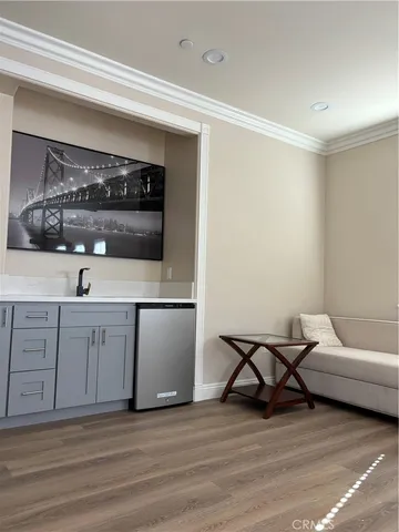 a living room with furniture and a kitchen view