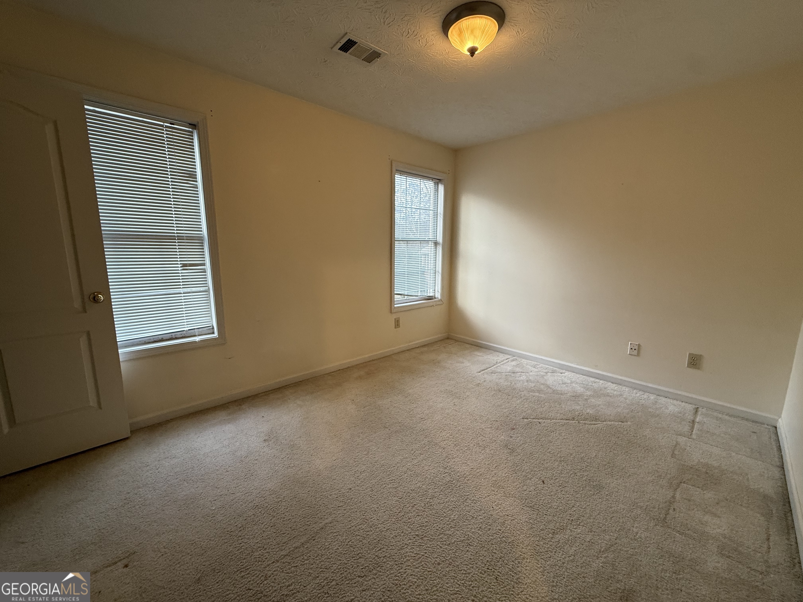 1716 Inlet Cove Court Snellville, GA 30078 - Photo 11 of 17 an empty room with windows
