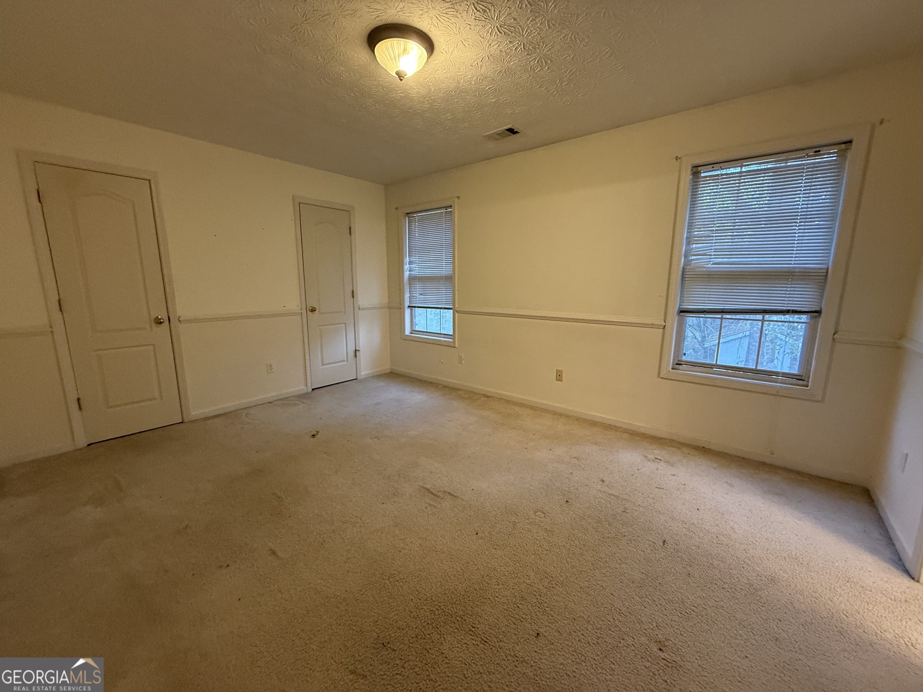 1716 Inlet Cove Court Snellville, GA 30078 - Photo 12 of 17 an empty room with windows
