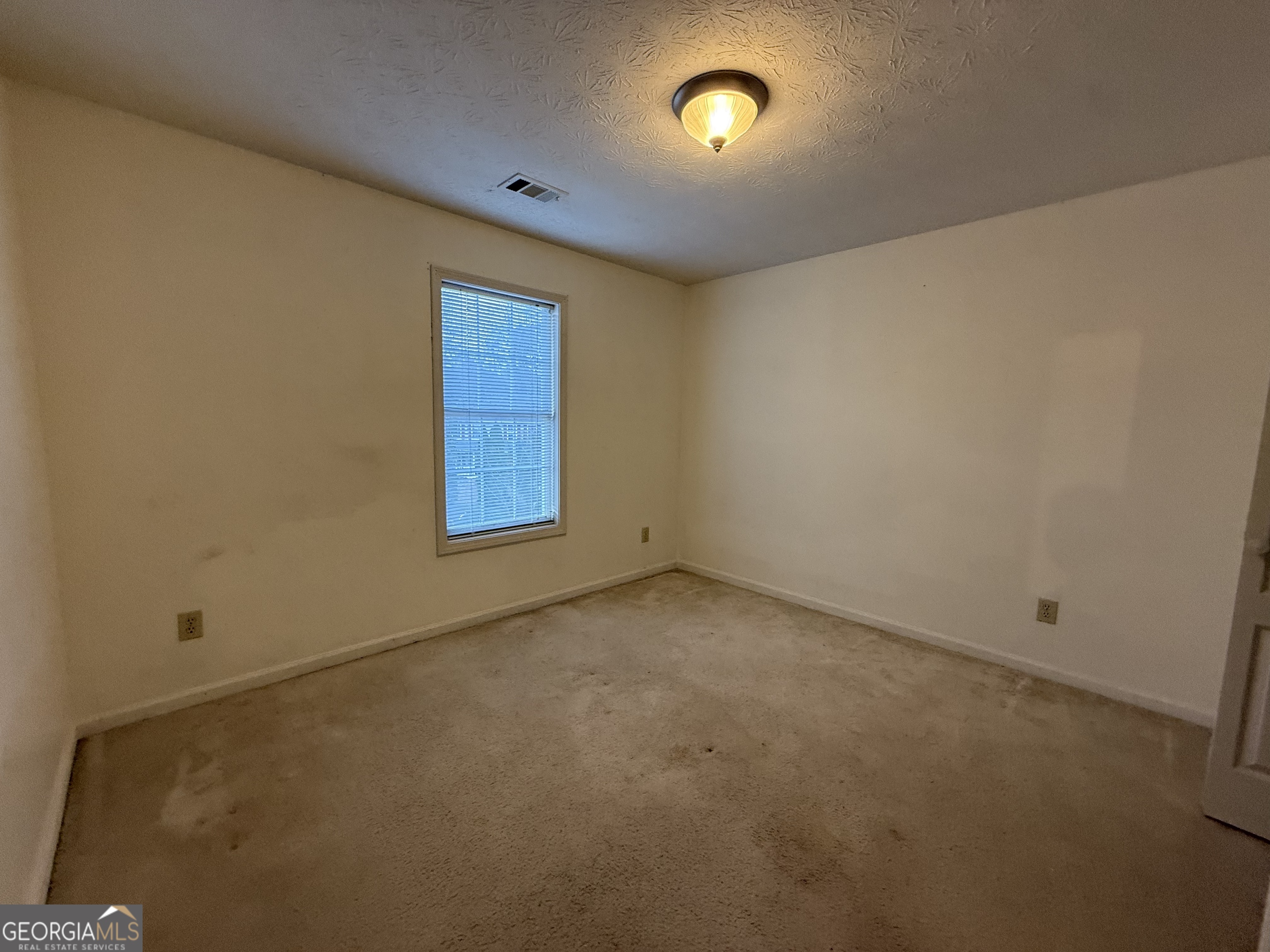 1716 Inlet Cove Court Snellville, GA 30078 - Photo 13 of 17 an empty room with windows