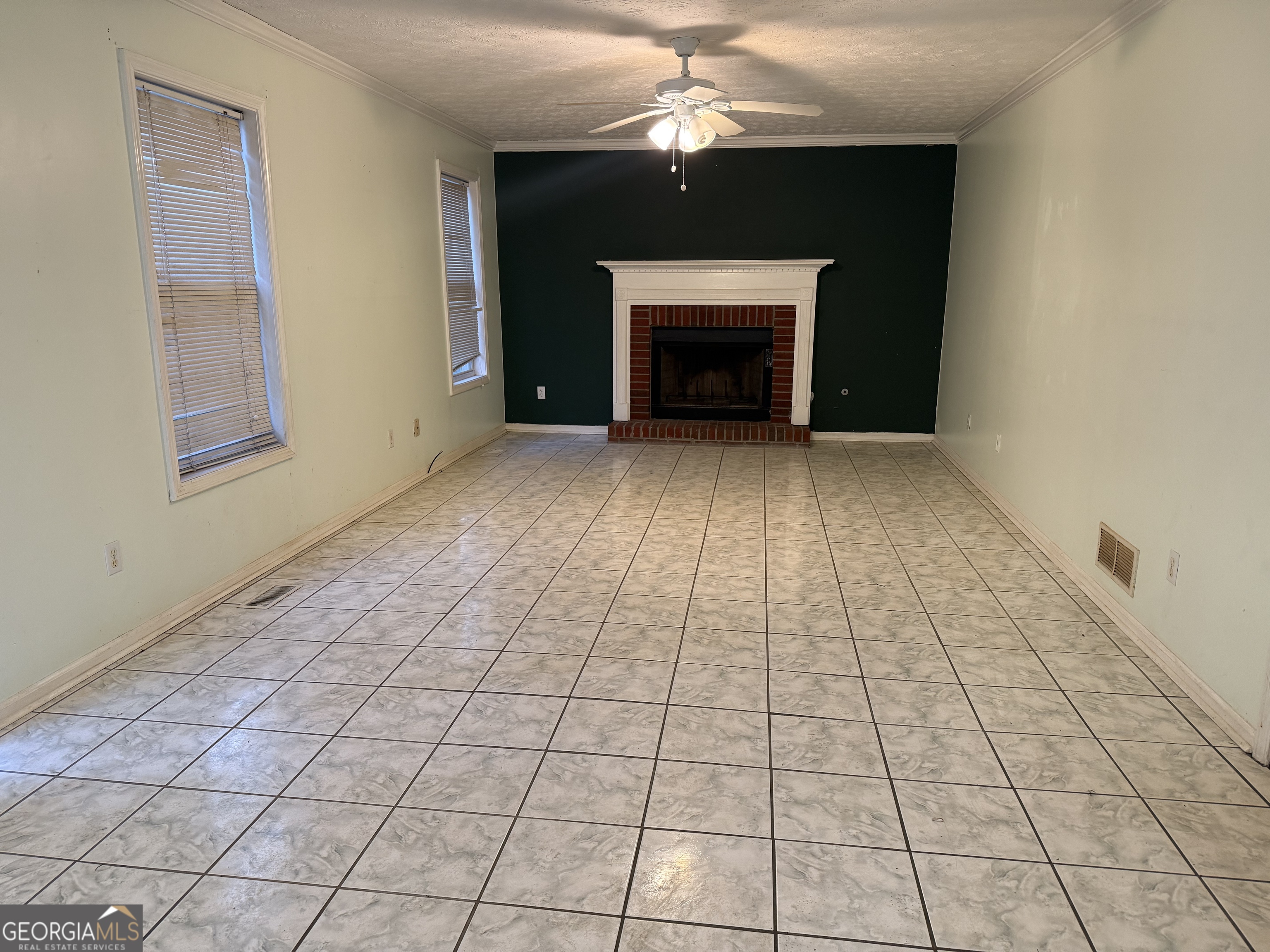 1716 Inlet Cove Court Snellville, GA 30078 - Photo 4 of 17 an empty room with windows and a fireplace