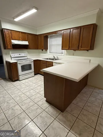 a kitchen with stainless steel appliances a stove sink and microwave