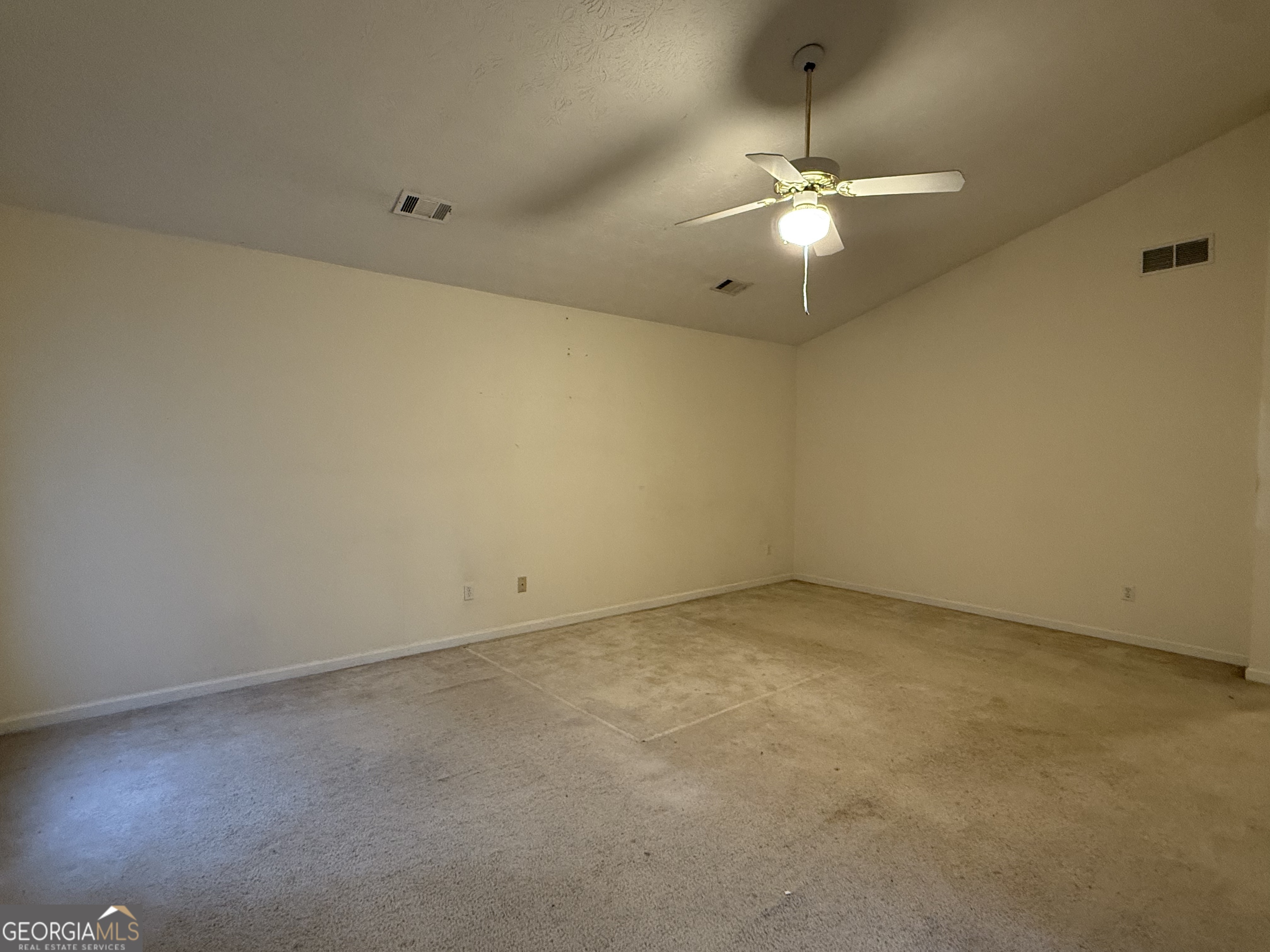 1716 Inlet Cove Court Snellville, GA 30078 - Photo 8 of 17 an empty room with a chandelier fan and windows