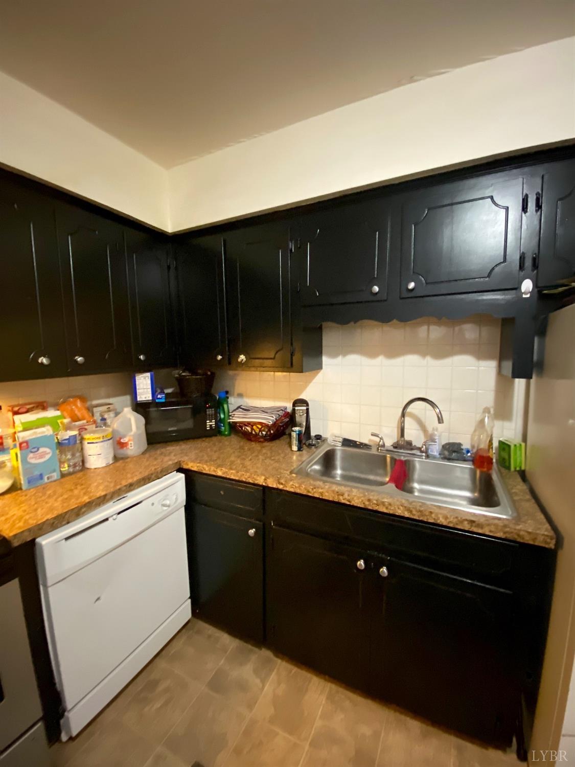 400 Riverside Drive Lynchburg, VA 24503 - Photo 16 of 40 a kitchen with granite countertop a sink cabinets and stainless steel appliances