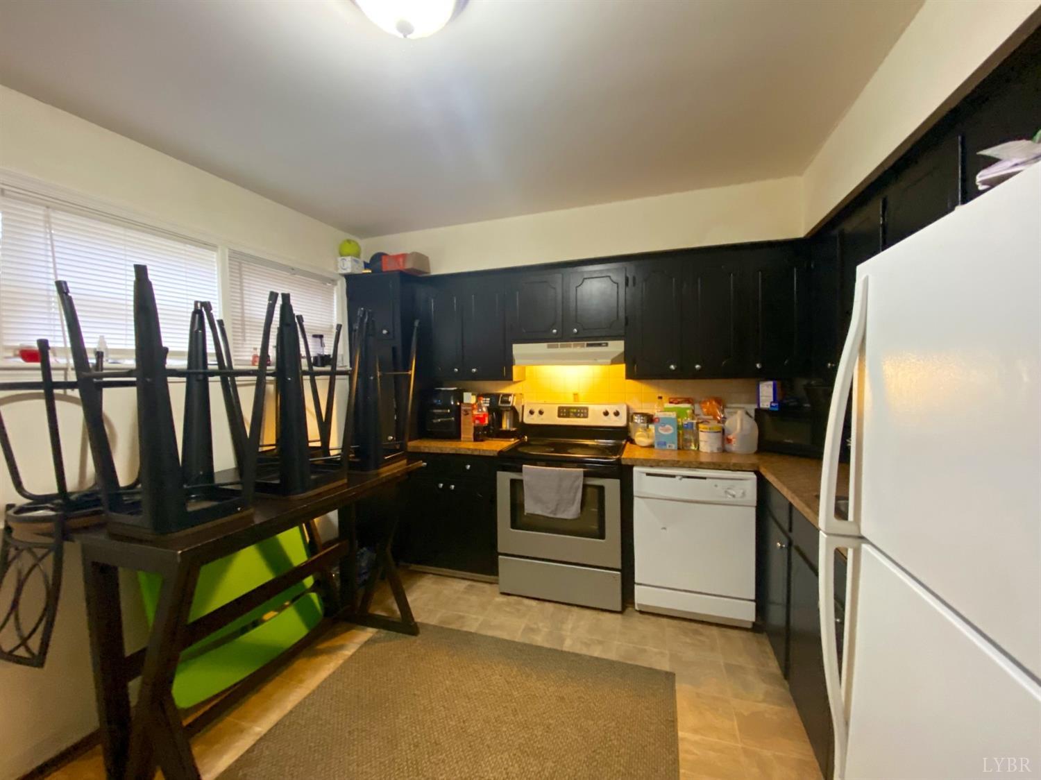 400 Riverside Drive Lynchburg, VA 24503 - Photo 17 of 40 a kitchen with refrigerator and chairs