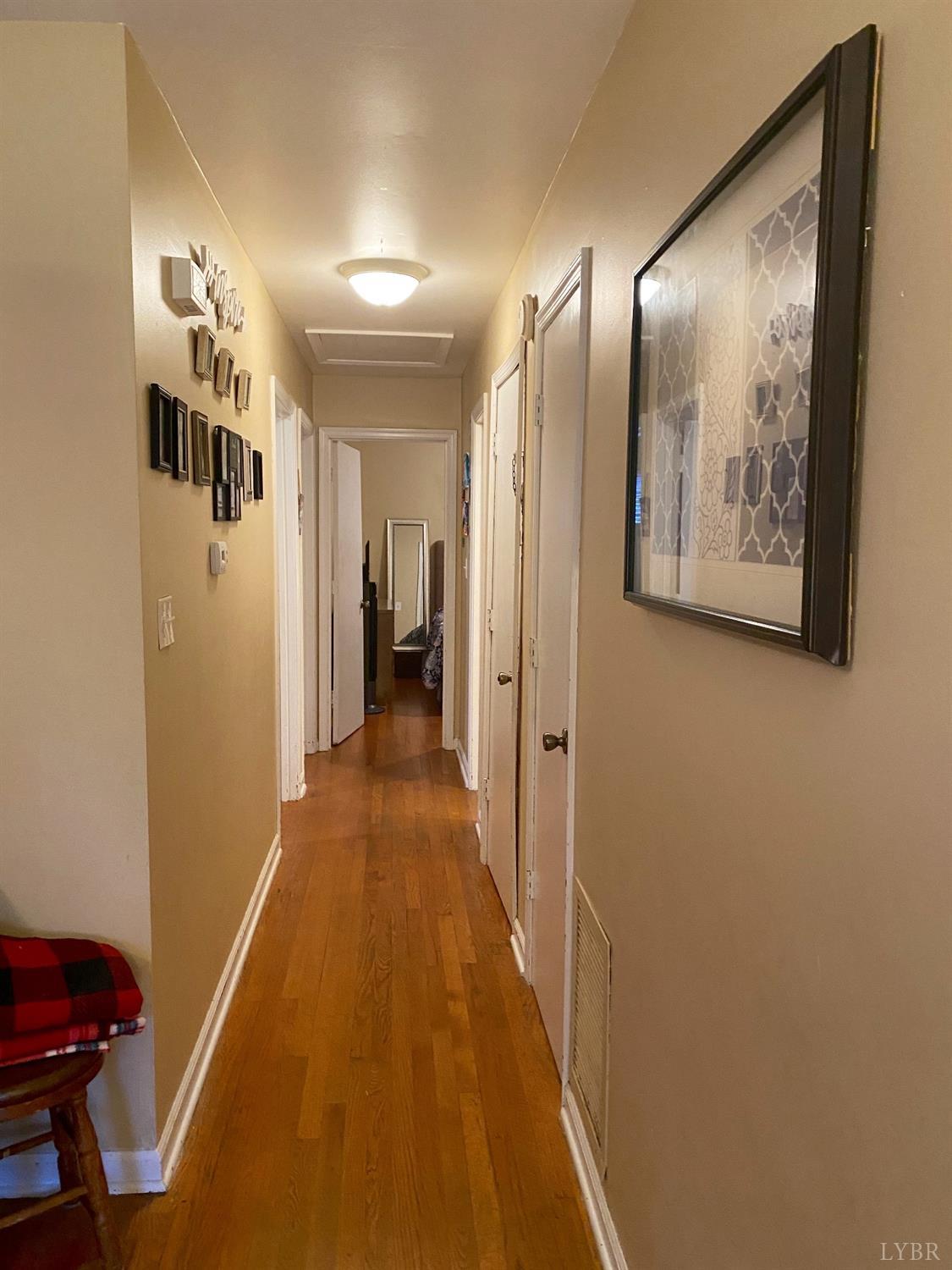 400 Riverside Drive Lynchburg, VA 24503 - Photo 27 of 40 a view of a hallway with paintings on the wall