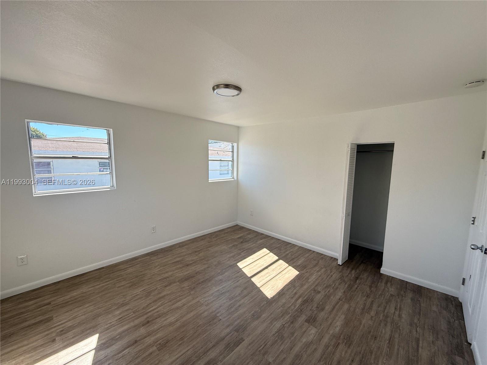 236 Southwest 10th Avenue, Unit B Miami, FL 33130 - Photo 5 of 11 a view of empty room with wooden floor and fan