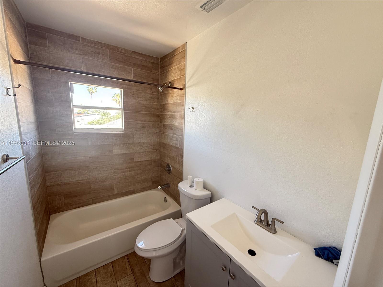 236 Southwest 10th Avenue, Unit B Miami, FL 33130 - Photo 8 of 11 a bathroom with a sink and a bathtub
