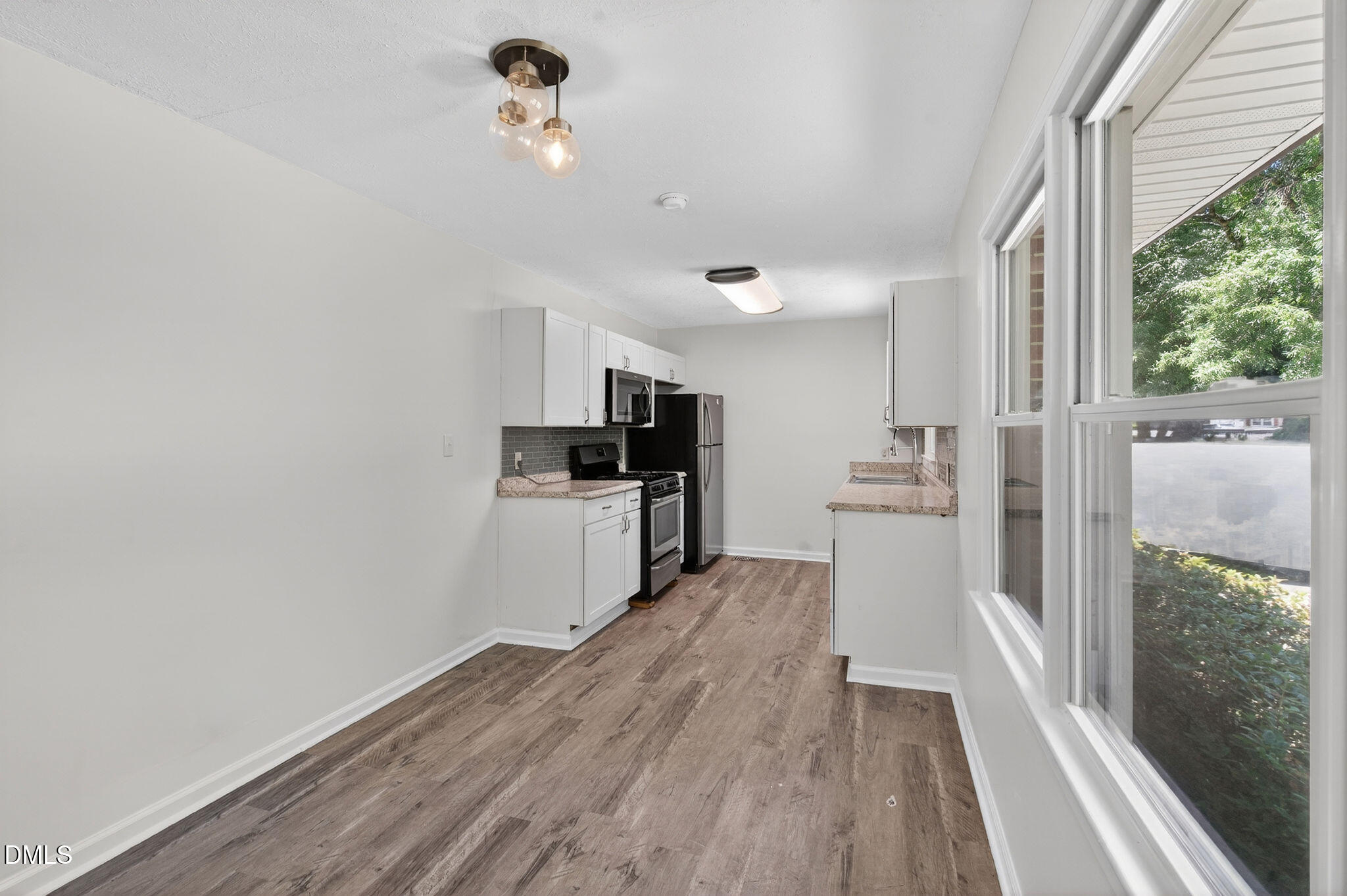 904 Seabrook Road Raleigh, NC 27610 - Photo 5 of 31 a view of a kitchen with wooden floor
