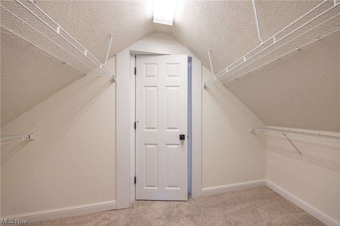 32887 Cedar Road Mayfield Heights, OH 44124 - Photo 28 of 44 Walk in closet with light carpet and vaulted ceiling