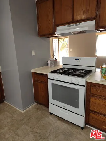 a stove top oven sitting inside of a kitchen
