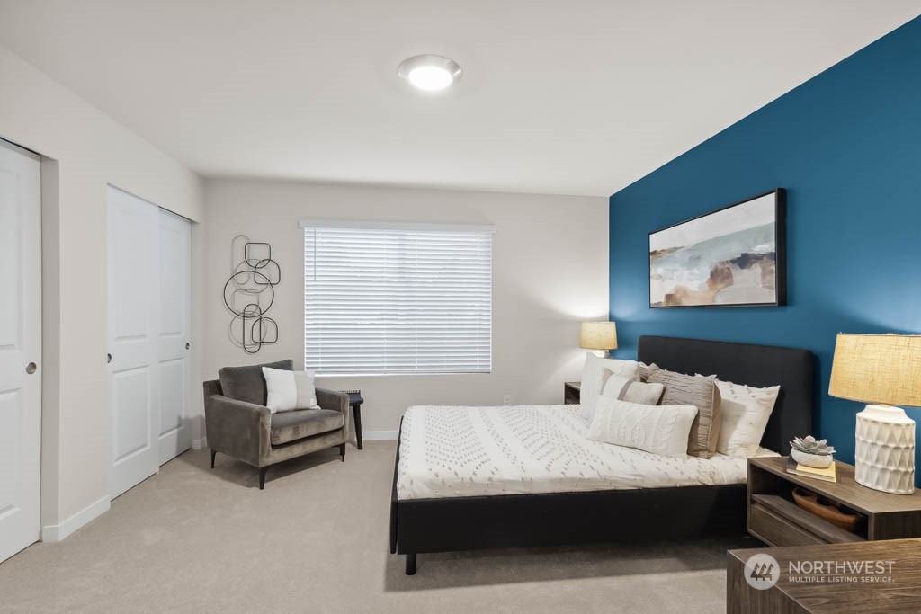 23413 Edmonds Way, Unit E2 Edmonds, WA 98026 - Photo 16 of 22 a bedroom with furniture and a lamp