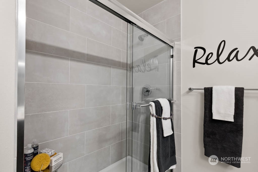 23413 Edmonds Way, Unit E2 Edmonds, WA 98026 - Photo 20 of 22 a bathroom with a shower and a sink