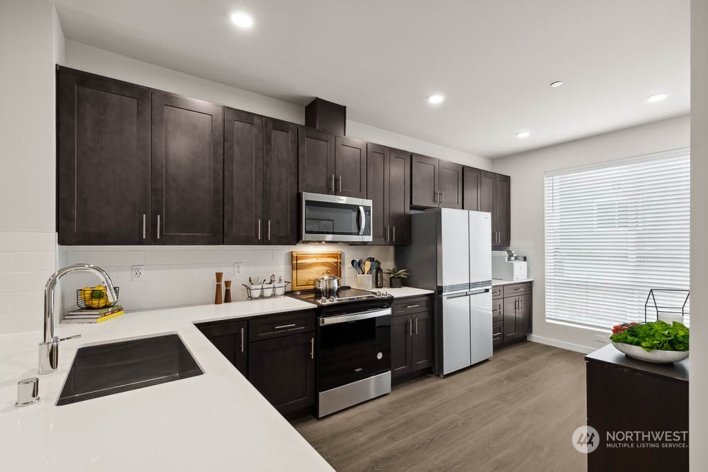 23413 Edmonds Way, Unit E2 Edmonds, WA 98026 - Photo 7 of 22 a kitchen with a sink a stove and refrigerator