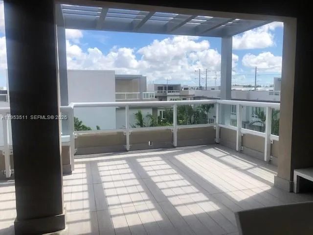 a view of a kitchen with wooden floor and electronic appliances