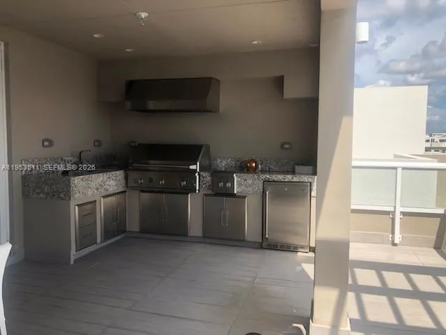 a dining room with furniture and a floor to ceiling window