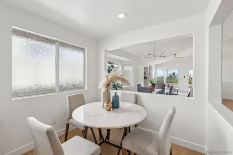 a dining room with furniture and window