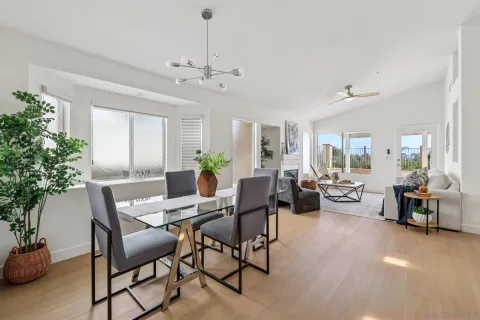 a view of a dining room with furniture and chandelier