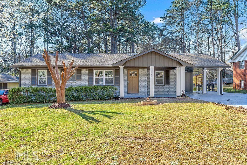 1133 Dove Valley Road Decatur, GA 30032 - Photo 1 of 1 a front view of a house with a yard