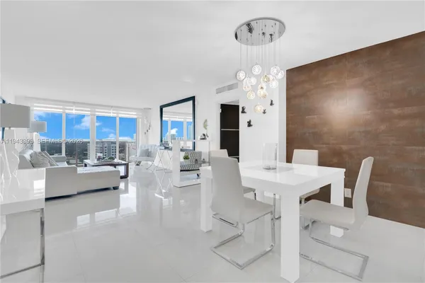 a view of a dining room with furniture and chandelier