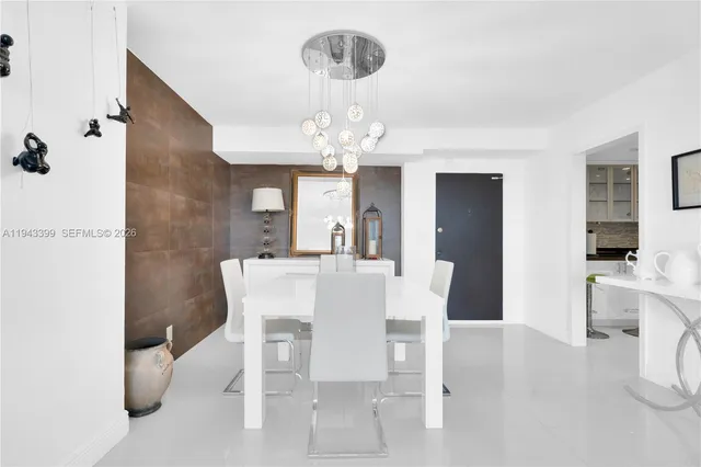 a kitchen with a table chairs and white cabinets