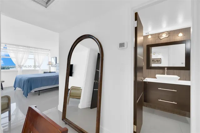 a bathroom with a sink a toilet a mirror and shower