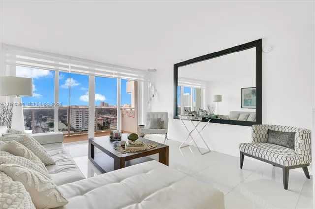 a living room with furniture and a floor to ceiling window