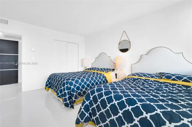 a bathroom with a sink a toilet a mirror and shower