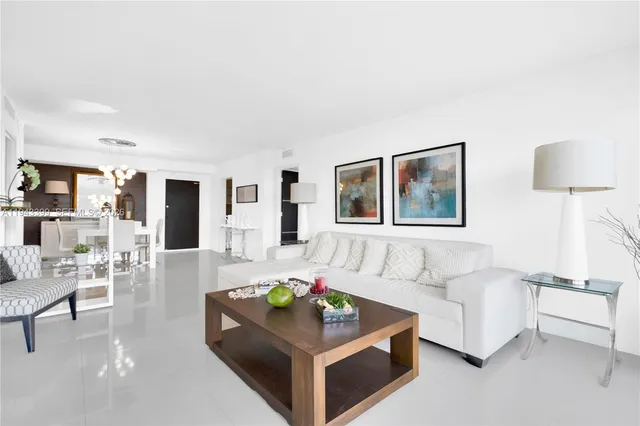 a living room with furniture a dining table and chairs