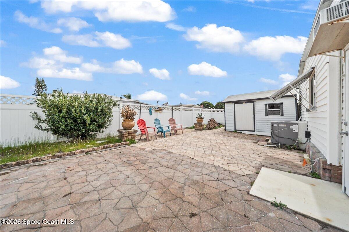 1813 Coco Plum Street Northeast Palm Bay, FL 32905 - Photo 22 of 44 a view of a house with backyard and sitting area