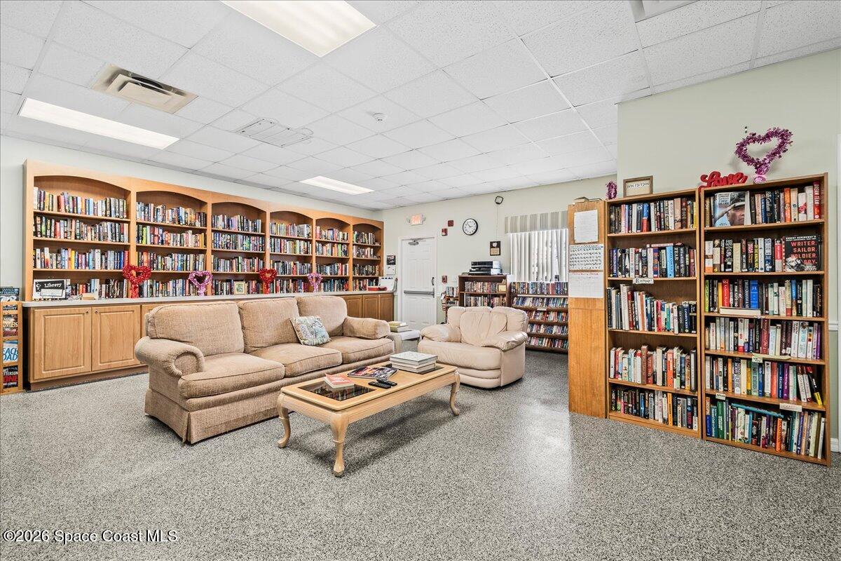 1813 Coco Plum Street Northeast Palm Bay, FL 32905 - Photo 41 of 44 a living room with furniture and a book shelf