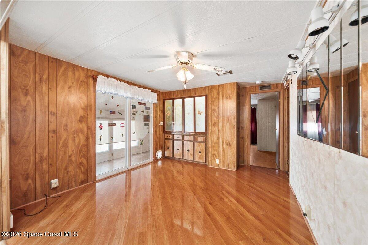 1813 Coco Plum Street Northeast Palm Bay, FL 32905 - Photo 8 of 44 wooden floor in an empty room with a window