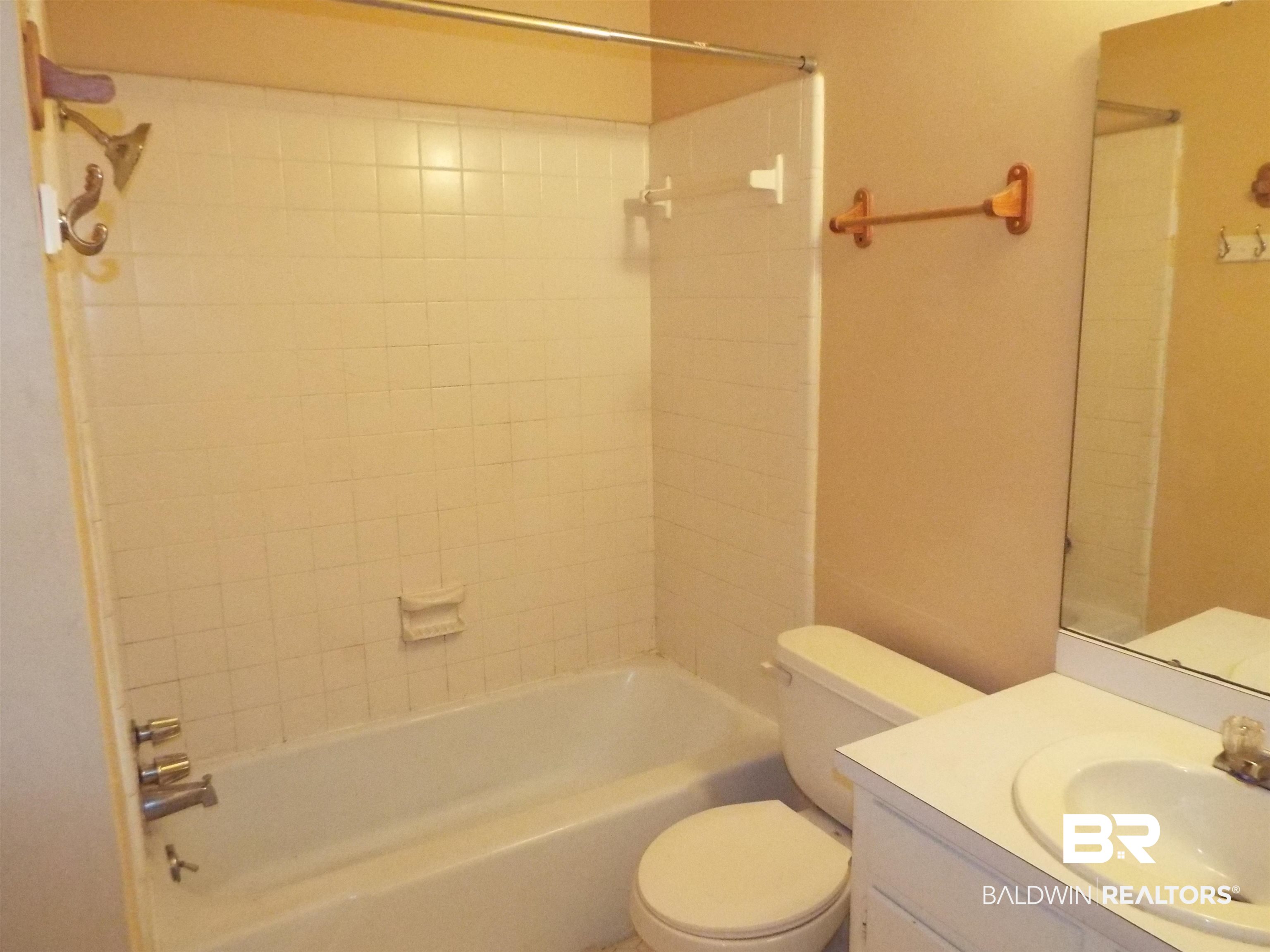 604 Southern Way Spanish Fort, AL 36527 - Photo 7 of 13 Full bathroom featuring vanity, tiled shower / bath combo, and toilet