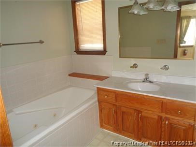 620 Myra Road Raeford, NC 28376 - Photo 21 of 38 a bathroom with a sink and a bathtub