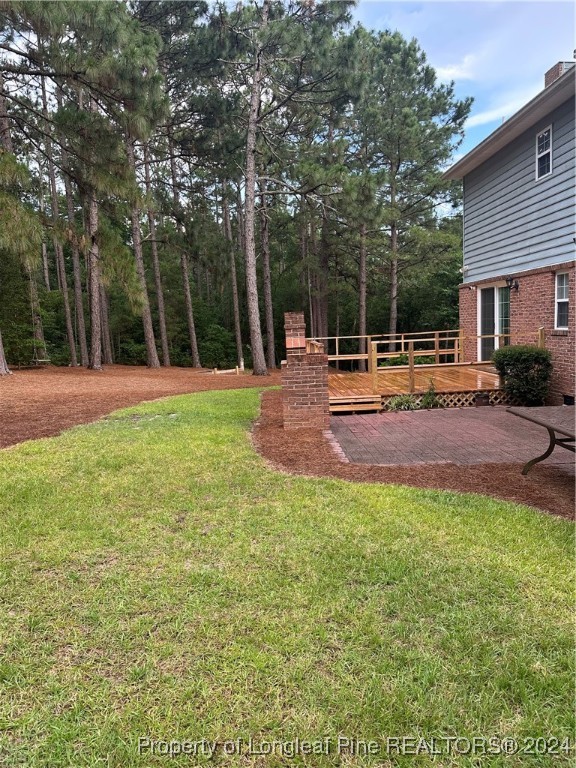 620 Myra Road Raeford, NC 28376 - Photo 36 of 38 a backyard of a house with table and chairs