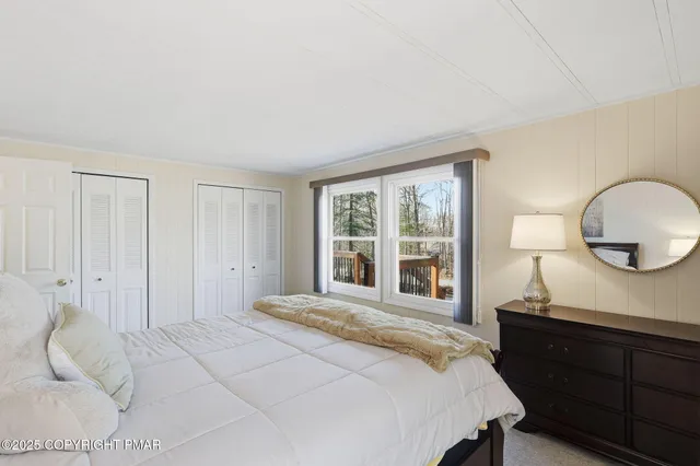 a bedroom with a large bed and a window