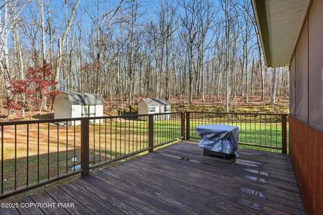 a view of balcony with furniture and wooden deck
