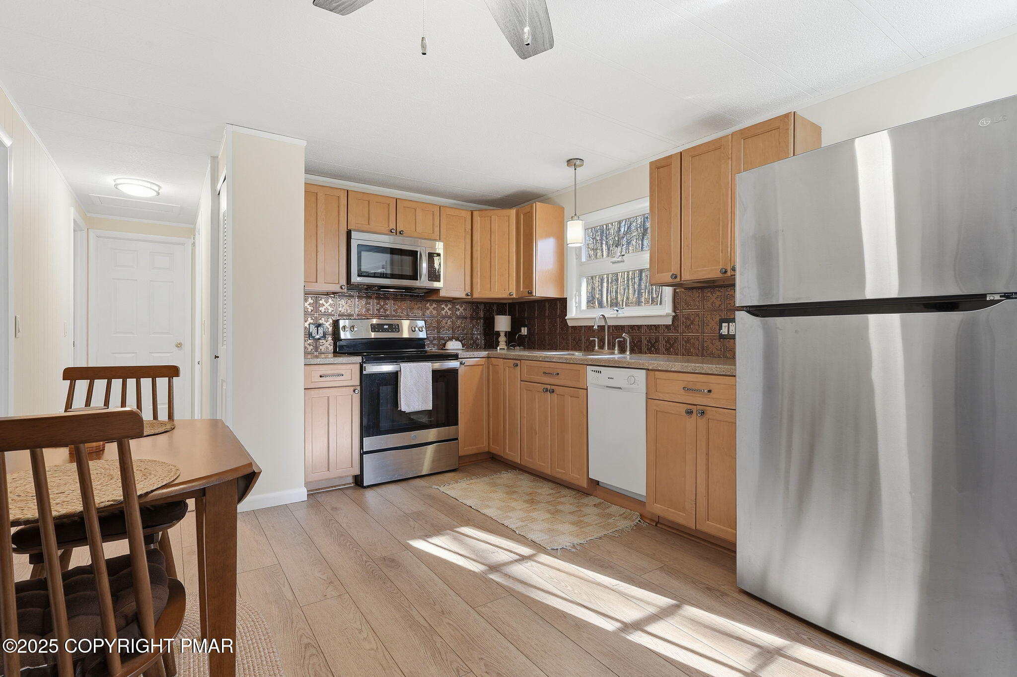 364 Welcome Lake Road Beach Lake, PA 18405 - Photo 8 of 46 a kitchen with granite countertop a refrigerator a sink dishwasher and a stove with wooden floor