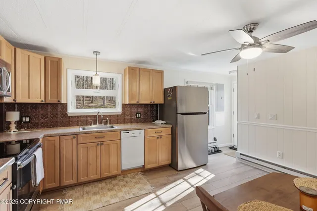 a kitchen with a refrigerator a sink and cabinets