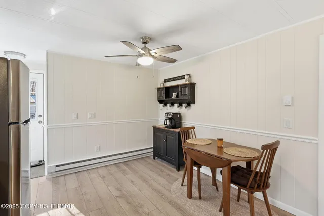 a view of a dining room with furniture and wooden floor