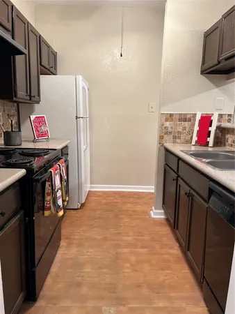 a kitchen with stainless steel appliances granite countertop a refrigerator and a stove