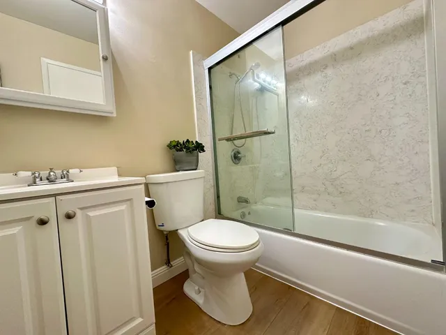 a bathroom with a sink toilet and shower
