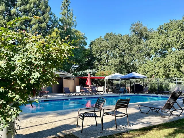 a view of swimming pool with outdoor seating