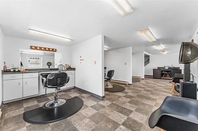 a room with furniture a rug and gym equipment