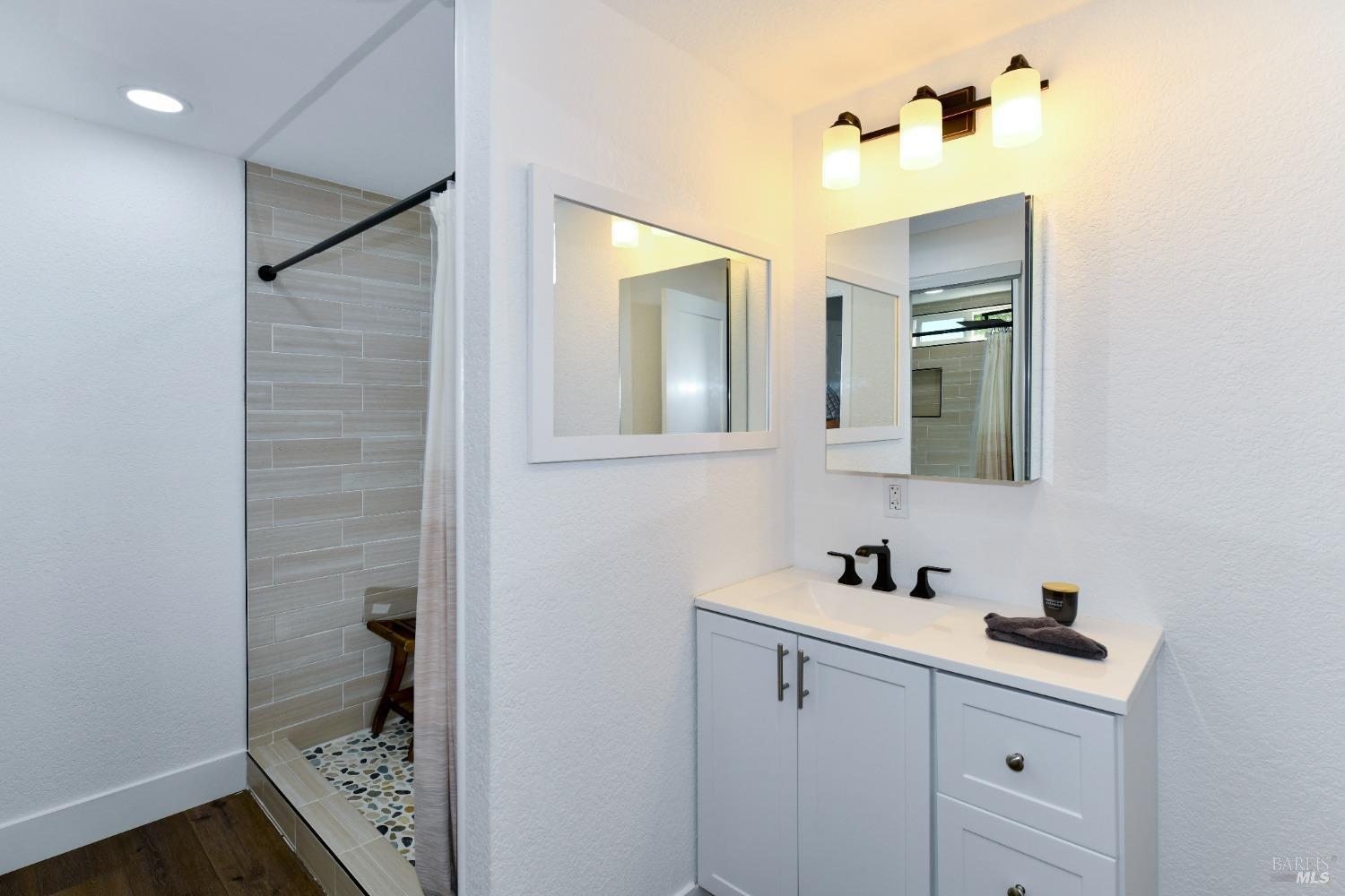 541 Mason Street, Unit 8 Healdsburg, CA 95448 - Photo 11 of 24 a bathroom with a sink a light fixture and a mirror