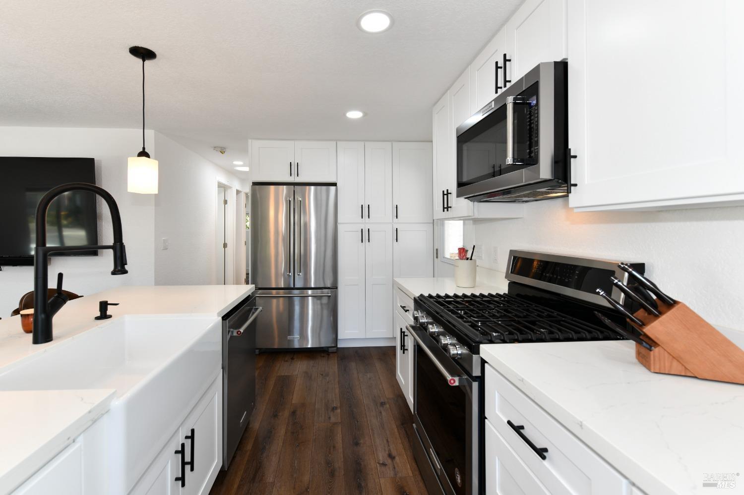 541 Mason Street, Unit 8 Healdsburg, CA 95448 - Photo 6 of 24 a kitchen with stainless steel appliances granite countertop a sink stove and refrigerator