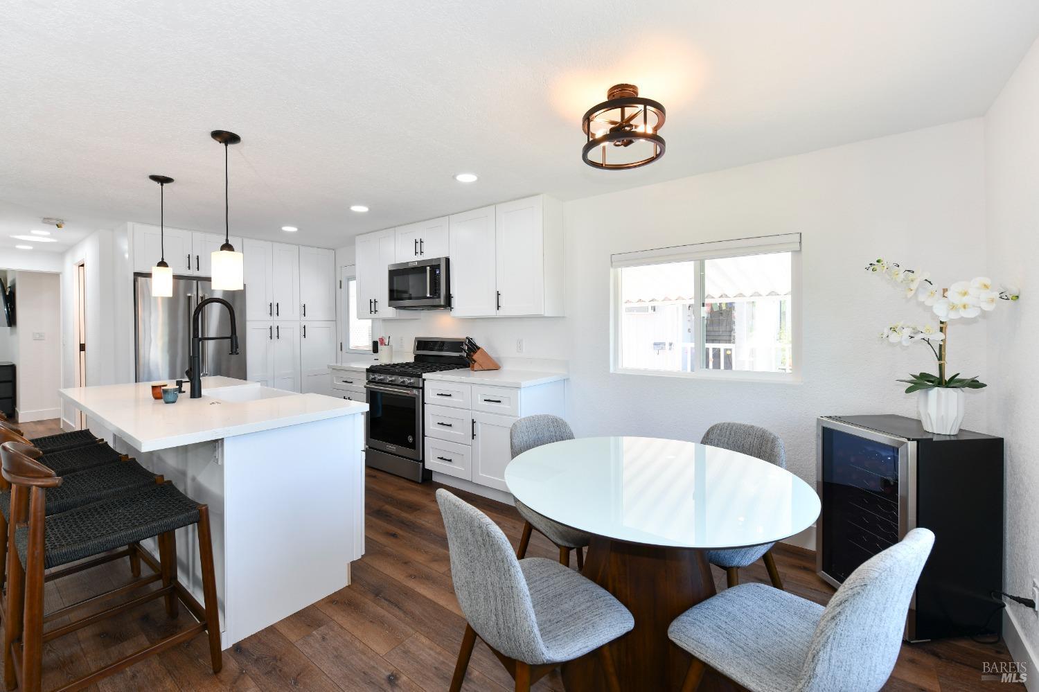 541 Mason Street, Unit 8 Healdsburg, CA 95448 - Photo 9 of 24 a kitchen with a dining table chairs and refrigerator